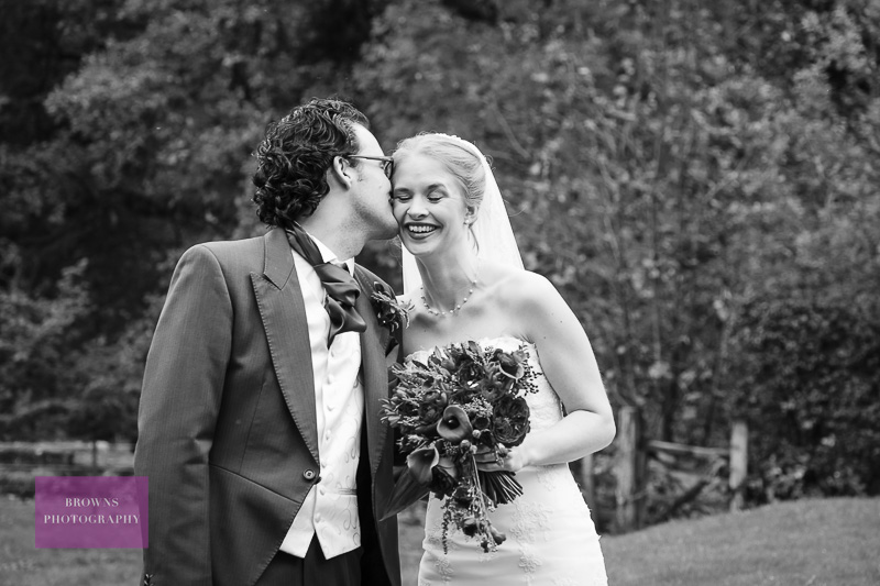 Portrait of bride and groom kissing at Brinkburn Priory