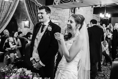 Bride and groom laughing at their wedding ceremony at Langley Castle