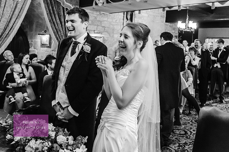 Bride and groom laughing at their wedding ceremony at Langley Castle